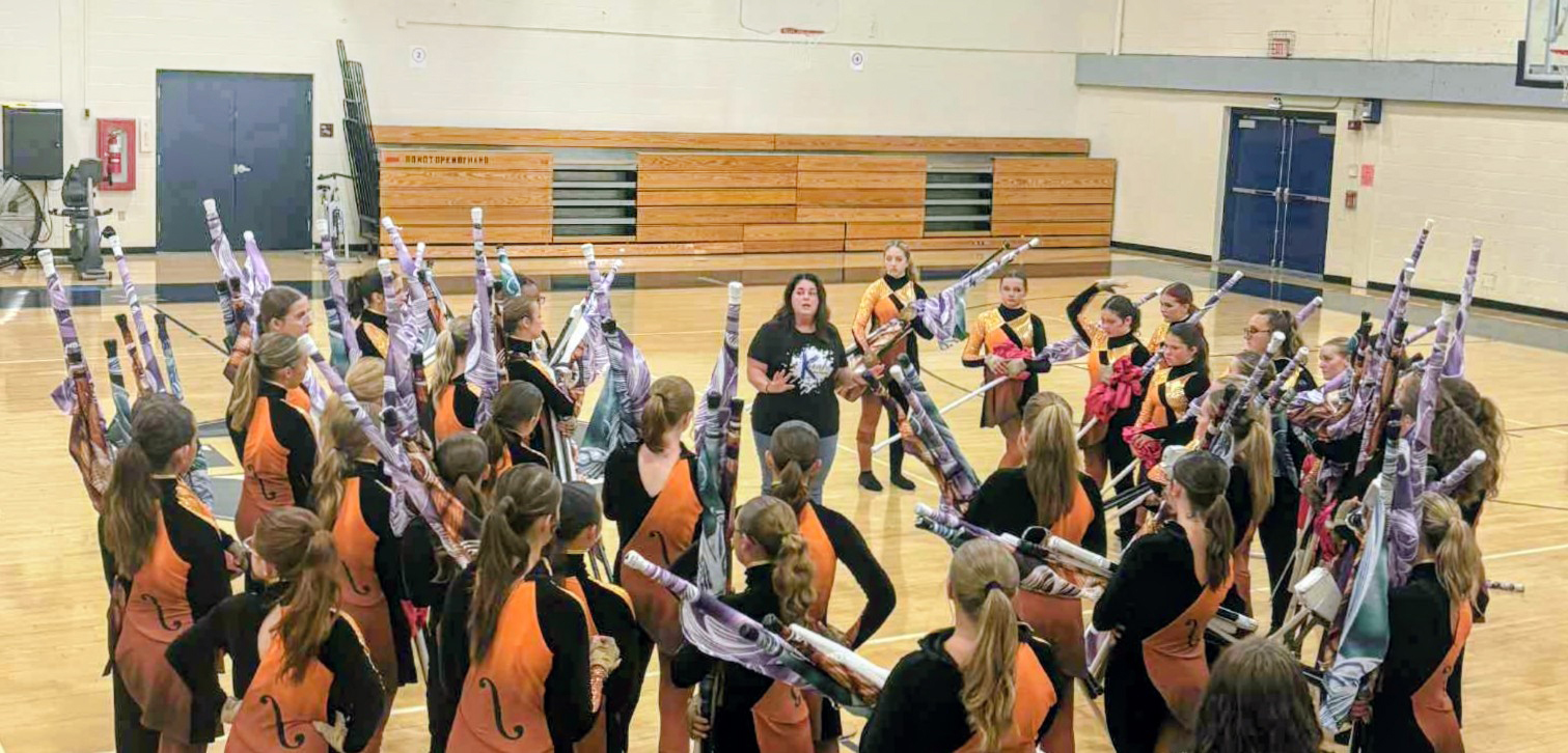 Alissa Getting Colorguard Ready for a Performance